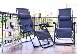 two chairs and a table on a balcony at Korali in Symi