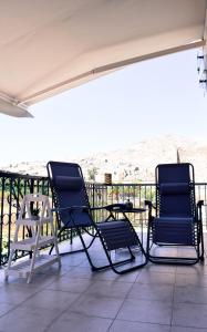 two chairs and a table on a patio at Korali in Symi