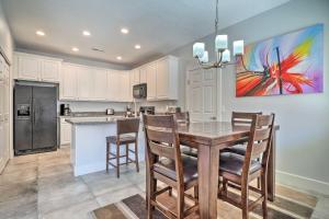 a kitchen with a table and chairs and a refrigerator at Dtwn Mesquite Condo with Resort Pool Golf and Gamble! in Mesquite