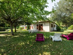 a group of chairs sitting in a yard at Beautiful villa with private garden in Pineuilh in Pineuilh