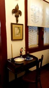 a wooden table with a plate on it in a room at Pousada Guignard in Ouro Preto