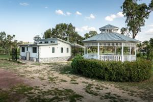 a white building with a gazebo in a park at Bella Vista Stanthorpe in Stanthorpe