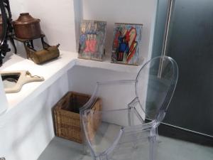 a clear chair sitting next to a bathroom sink at AMO Folegandros in Karavostasi