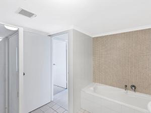 a white bathroom with a tub and a shower at Twin Shores 67 in The Entrance
