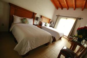 Postel nebo postele na pokoji v ubytování Hotel Concierge Flor y Canto