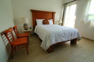 Postel nebo postele na pokoji v ubytování Hotel Concierge Flor y Canto