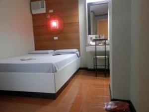 Ένα ή περισσότερα κρεβάτια σε δωμάτιο στο Hotel Sogo Banawe