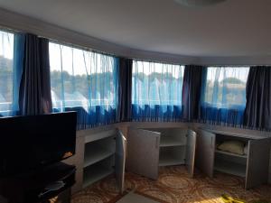 a room with windows and a flat screen tv at Apartment on Demenchuka 19 in Fontanka
