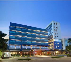 a large blue building with a lot of windows at Swiss-Belinn Wahid Hasyim in Jakarta