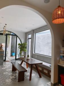 a living room with a table and a window at Lacasa Homestay in Hue