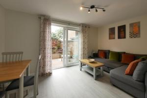 a living room with a couch and a table at Crewe Short Lets 8 Victoria Court, Crewe in Crewe