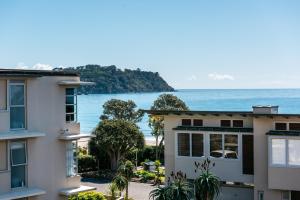a view of the ocean from a building at Sanctuary On The Beach - Onetangi by Waiheke Unlimited in Onetangi