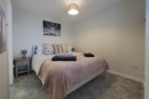 a bedroom with a bed with two pillows on it at Crewe Short Lets 8 Victoria Court, Crewe in Crewe
