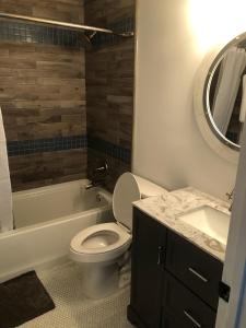 a bathroom with a toilet and a sink and a mirror at Vacation Bliss LLC in Hilton Head Island