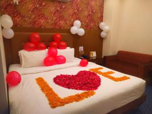 a bed with a white bedspread and pillows at Hotel Grand View 1 & 2 in Sylhet