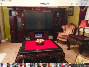 a living room with a tv and a table with a red cloth at 3 BEDROOM SLEEPs 8 NICE SPACIOUS APARTMENT B 89 in Montgomery