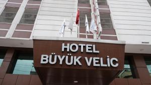 a hotel sign in front of a building at Buyuk Velic Hotel in Gaziantep