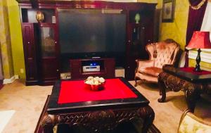 a living room with a tv and a red table at 2 BEDROOM SLEEPs 6 SPACIOUS LUXURY APARTMENT 79 in Montgomery