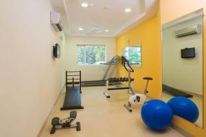 a gym with weights and exercise equipment in a room at Ginger Guwahati in Guwahati
