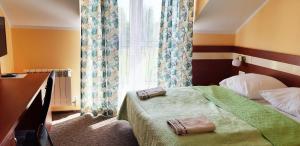 
Łóżko lub łóżka w pokoju w obiekcie Pensjonat Sielanka
