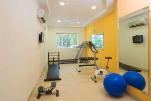 a gym with weights and exercise equipment in a room at Ginger Agartala in Agartala