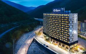 Jeongseon Intoraon Hotel في جونغ سون: تقديم فندق في الليل بجبال في الخلفية