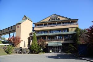 a large building with a sign on top of it at Fuji Time Traveler 玉手箱 in Fujikawaguchiko