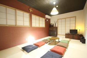 a room with a row of pillows on the floor at Fuji Time Traveler 玉手箱 in Fujikawaguchiko
