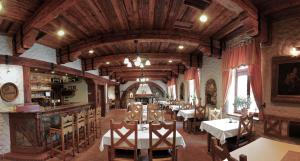 a dining room with tables and chairs in a building at KATERAIN hotel, restaurace, wellness in Opava