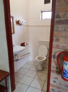 uma casa de banho com um WC e um lavatório em Guesthouse 914 em Sabie