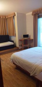 Postel nebo postele na pokoji v ubytování Hotel Villa Fosine
