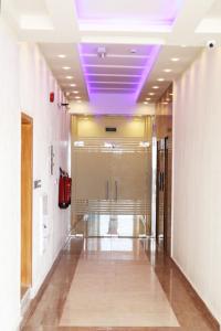 a hallway with a purple ceiling in a building at Roza Hotel Apartments in Muscat
