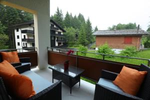 a balcony with couches and a table with a view at Casa Riposo in Flumserberg