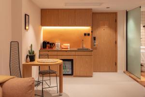 a kitchen with wooden cabinets and a table and a counter at the Figo in Hong Kong