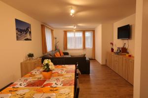 a living room with a couch and a table at Casa Riposo in Flumserberg