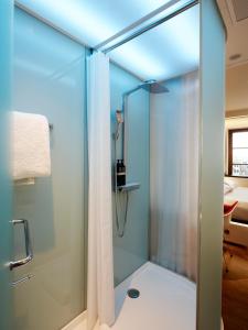 a bathroom with a shower and a toilet at citizenM Geneva in Geneva