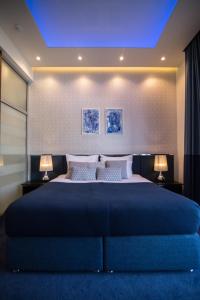 a bedroom with a large bed with a blue ceiling at SL Panorama in Trebinje