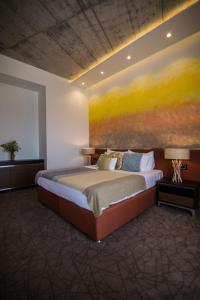 a bedroom with a bed with a painting on the wall at SL Panorama in Trebinje