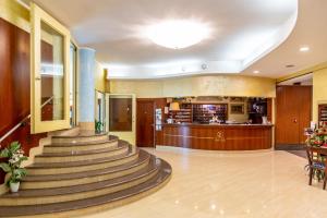 a lobby of a hotel with stairs and a bar at Hotel San Luca in Battipaglia