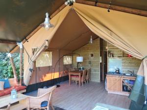 a tent with a table and chairs in it at Domaine Audubert in Saint-Antonin