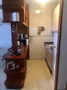 a small kitchen with a counter and a refrigerator at Apartamento Agaete Park in Playa del Ingles
