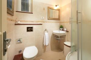 a bathroom with a toilet and a sink at Sun Spalato Beach in Split