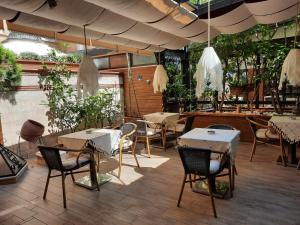 a restaurant with tables and chairs under a large umbrella at Boyuguzel Termal Hotel in Bursa