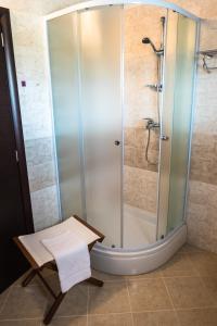 a shower with a glass door in a bathroom at Apartment-rooms Preka in Rab