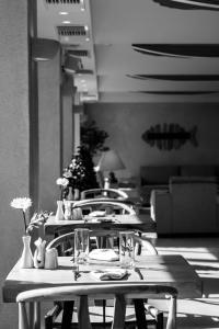 a group of tables and chairs in a restaurant at GARDELLI RESORT in Laganas