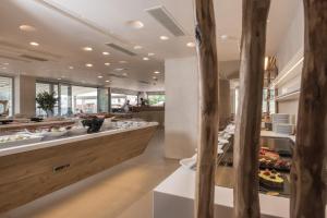 a restaurant with a long counter with food at GARDELLI RESORT in Laganas