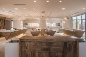 a hair salon with three sinks in a room at GARDELLI RESORT in Laganas