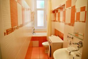 łazienka z umywalką, toaletą i oknem w obiekcie Apartman Sylva na Staré Louce 42 w Karlowych Warach