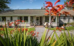 a house with a garden in front of it at Home Comforts in Peaceful 2 Acres in Inverness