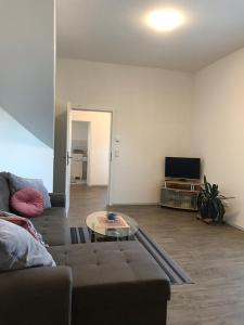a living room with a couch and a table at Ferienwohnung I in Papenburg